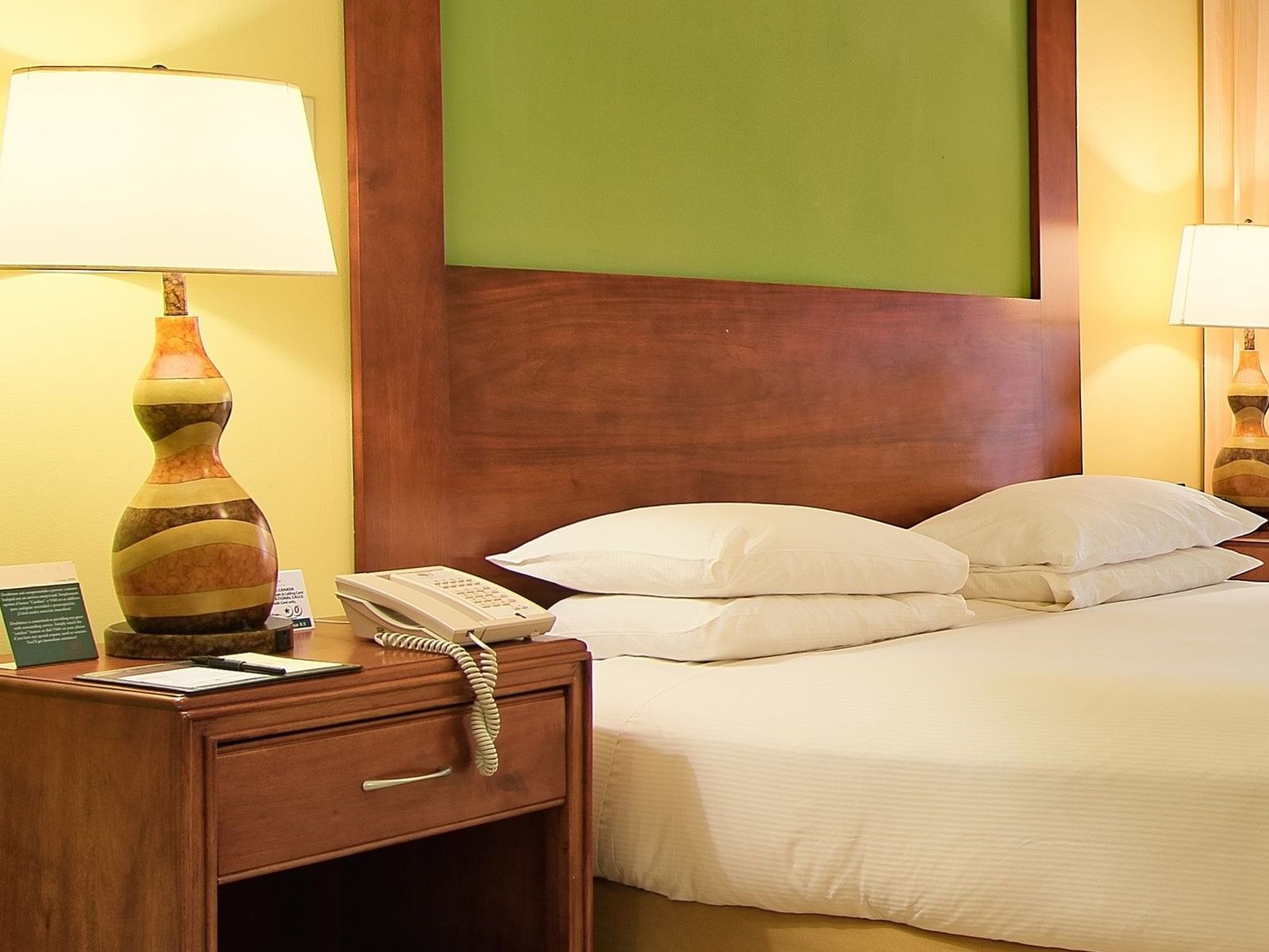 Bed & a nightstand in Ocean View 1 King Bed at Fiesta Resort