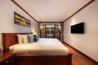 Bed facing TV in Superior Pondside View at U Luang Prabang