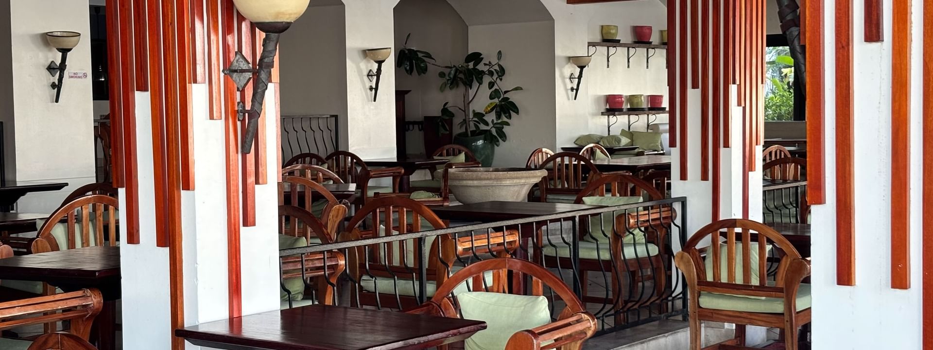 Dining area with wooden tables and chairs at Pappagallo restaurant, Warwick Fiji Resort and Spa, Korolevu