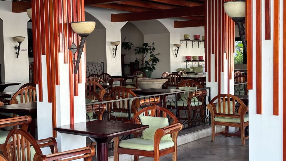 Dining area with wooden tables and chairs at Pappagallo restaurant, Warwick Fiji Resort and Spa, Korolevu.