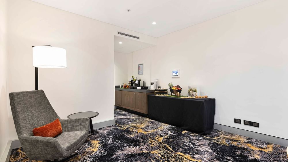 Comfortable lounge area with a refreshment station in The Riverina Boardroom at Novotel Sydney on Darling Harbour