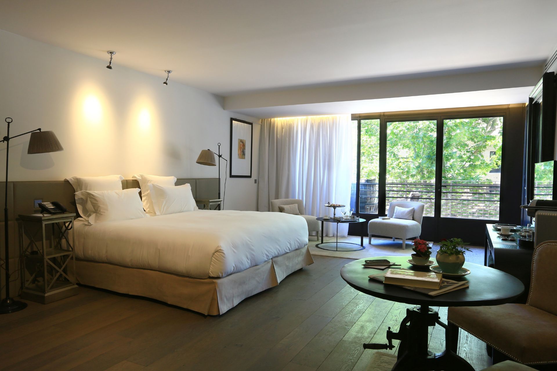 King bed, desk & lounge in a Suite at Domaine De Manville