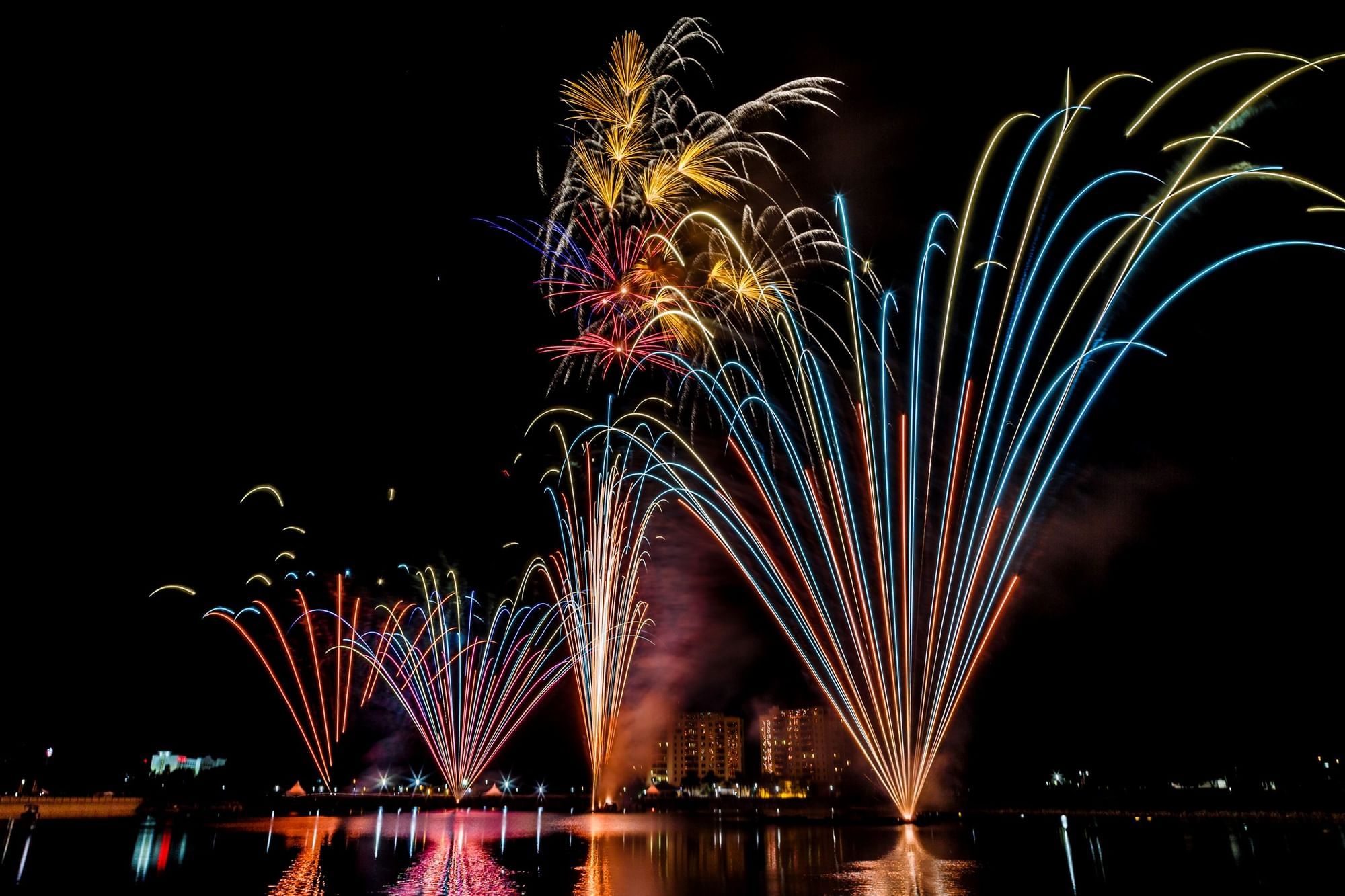 Firework show by a lake near Rosen Inn International