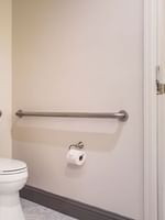 Accessible bathroom with toilet, grab bars, and roll-in shower at Warwick San Francisco in San Francisco.