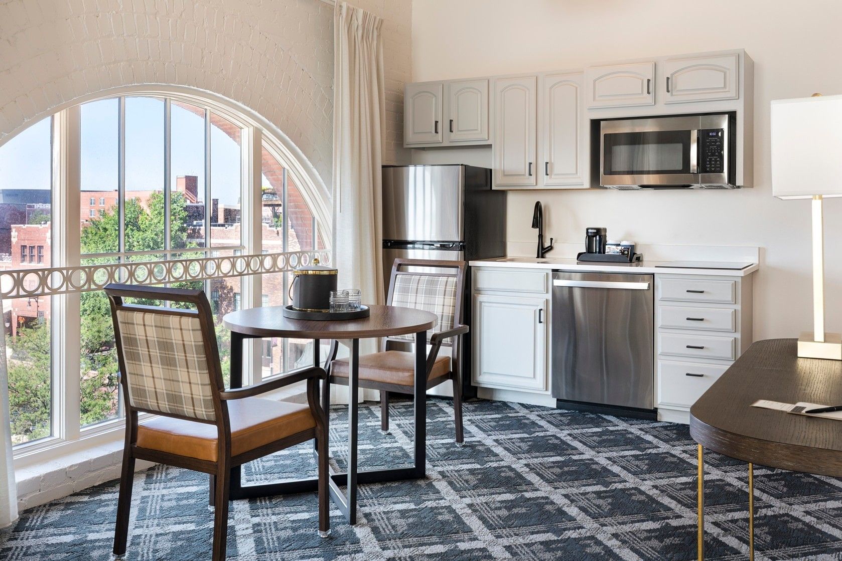 A small kitchenette with a dining area and a large window