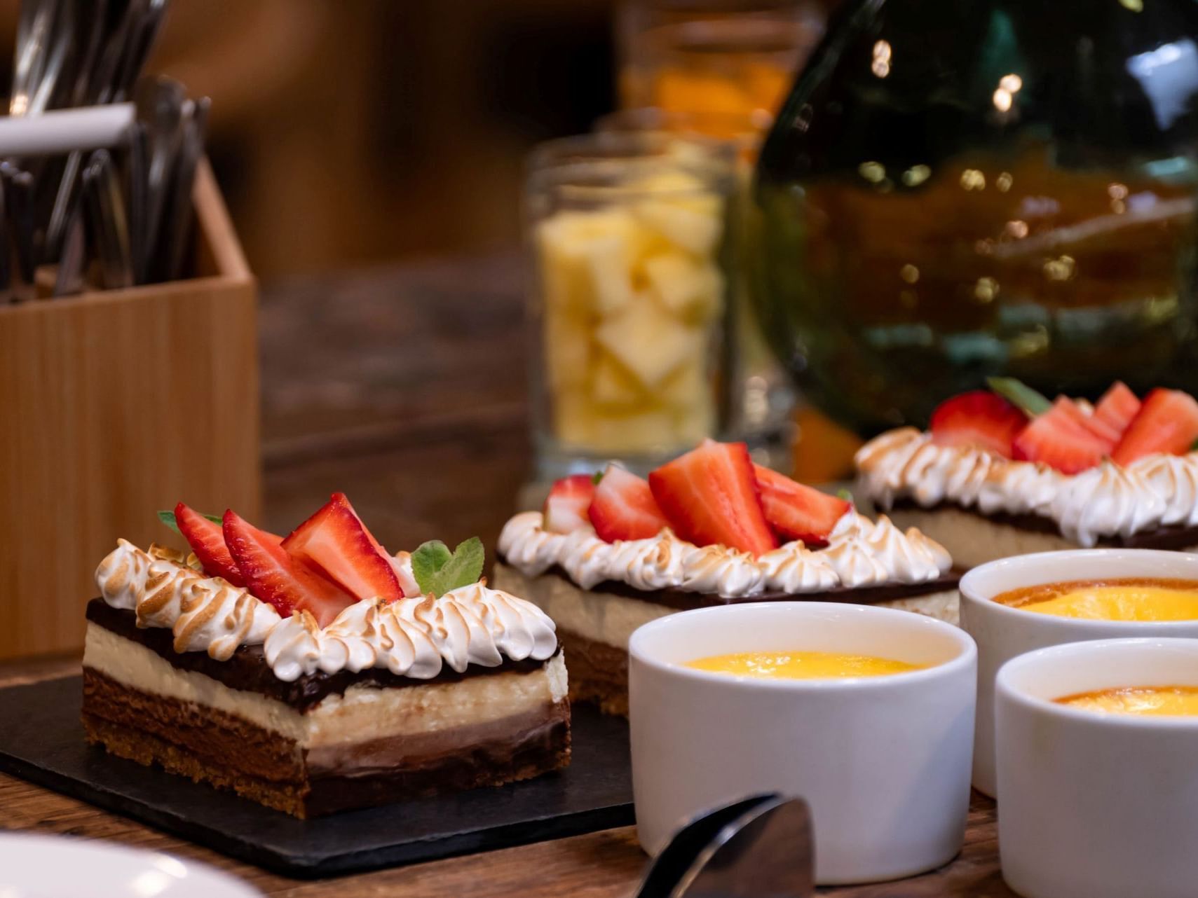 Postres con fresas y nata en cuencos sobre una mesa del hotel HCC Costanera Concepción.