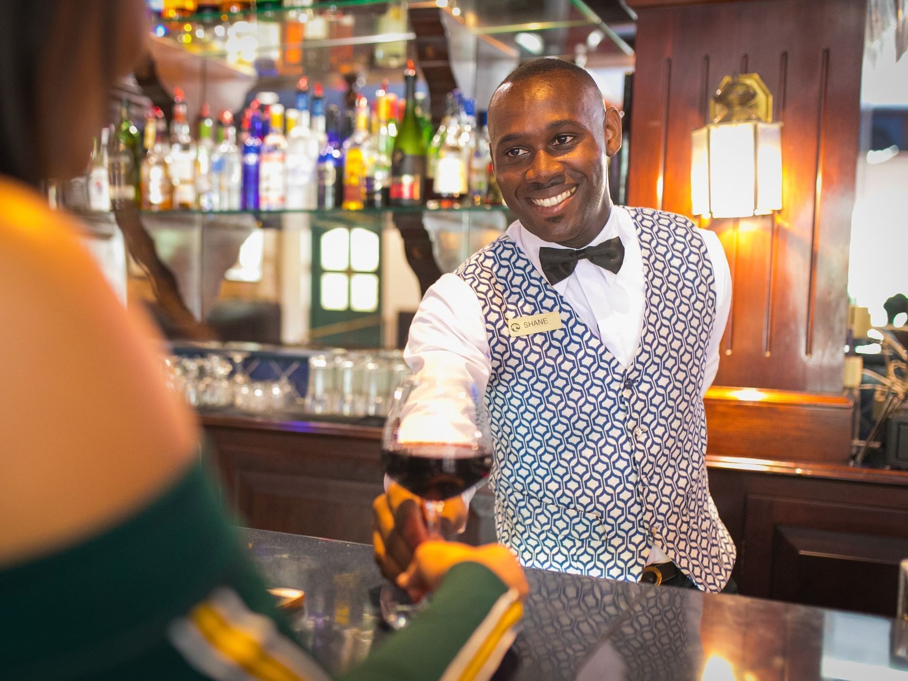 Bartender serving wine at Courtleigh Hotel & Suites