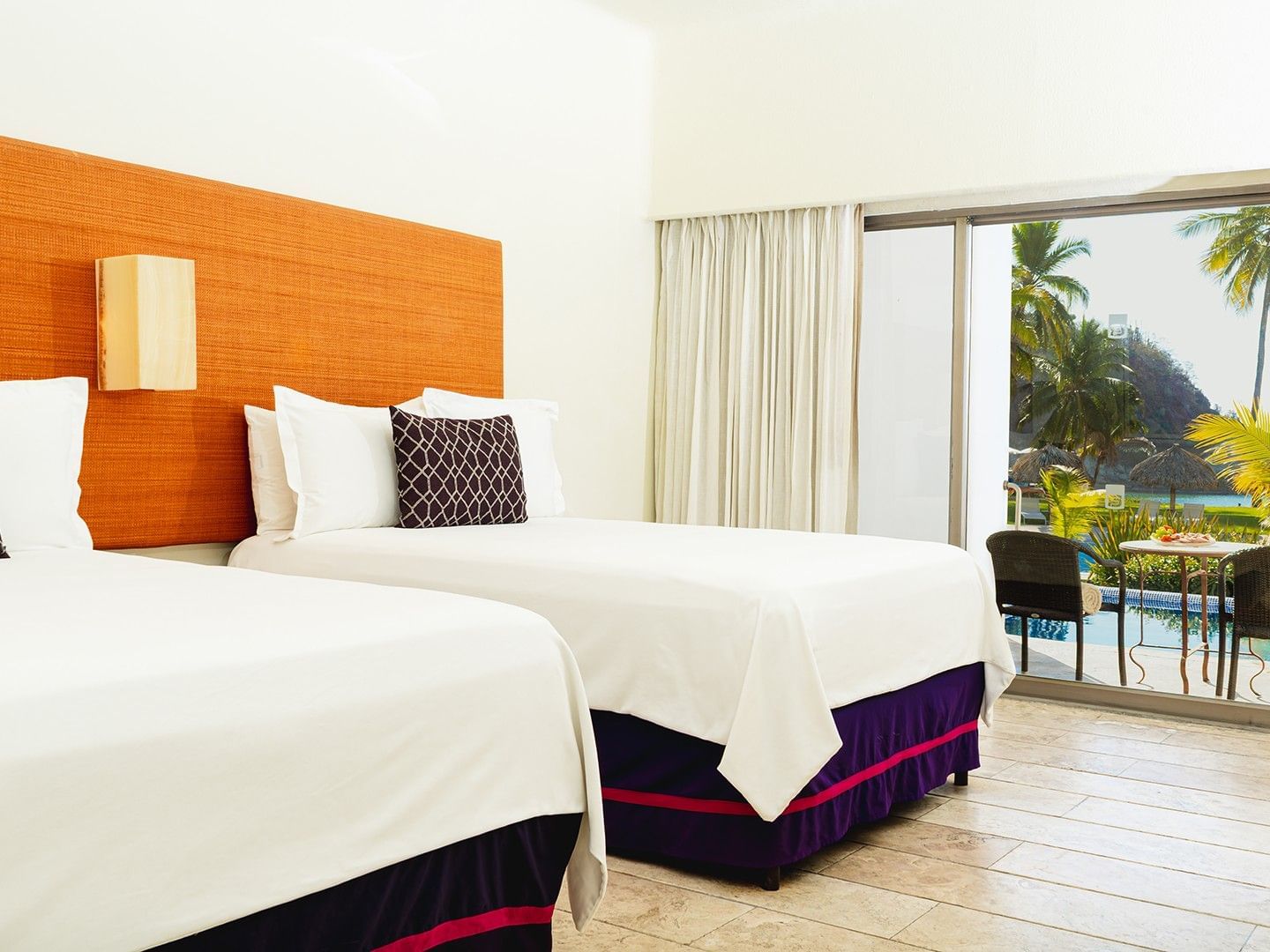 Two Double Deluxe Private Pool with cozy beds, wooden floors, and patio seating area at Camino Real Zaashila Huatulco