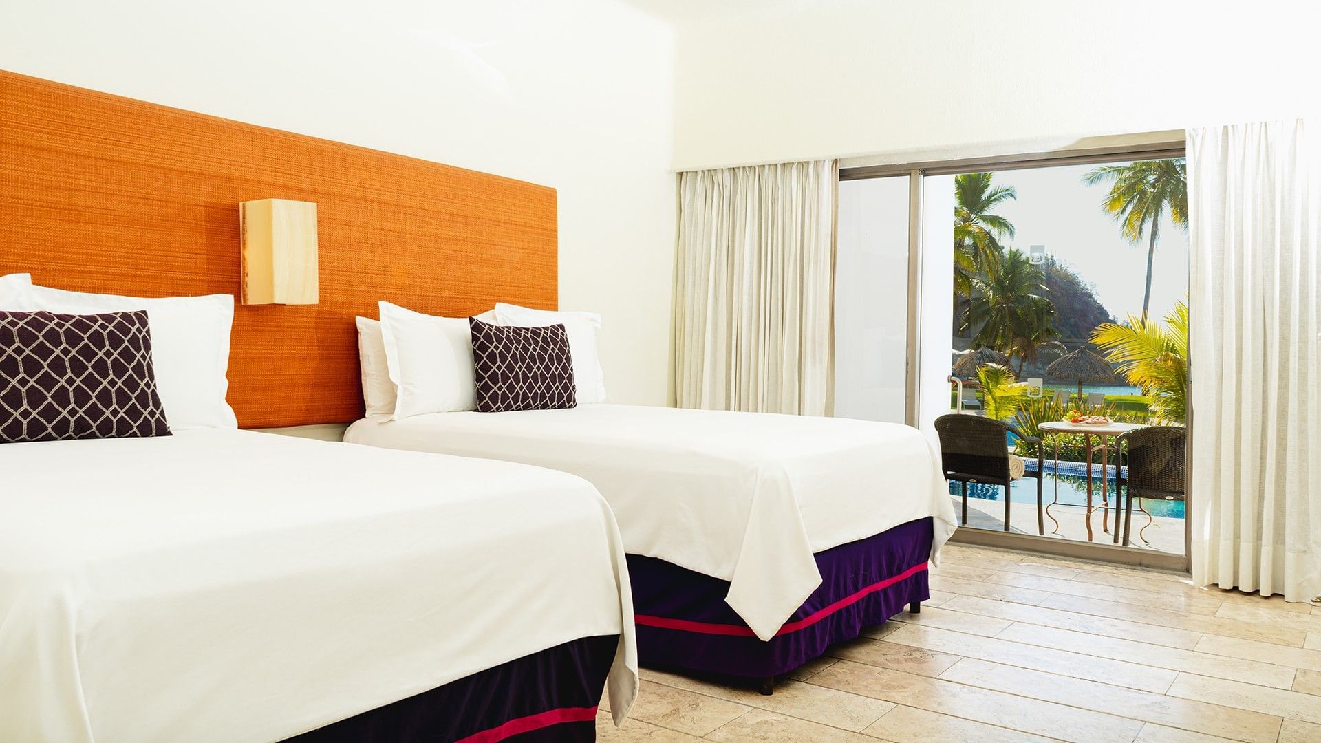 Two Double Deluxe Private Pool with cozy beds, wooden floors, and patio seating area at Camino Real Zaashila Huatulco