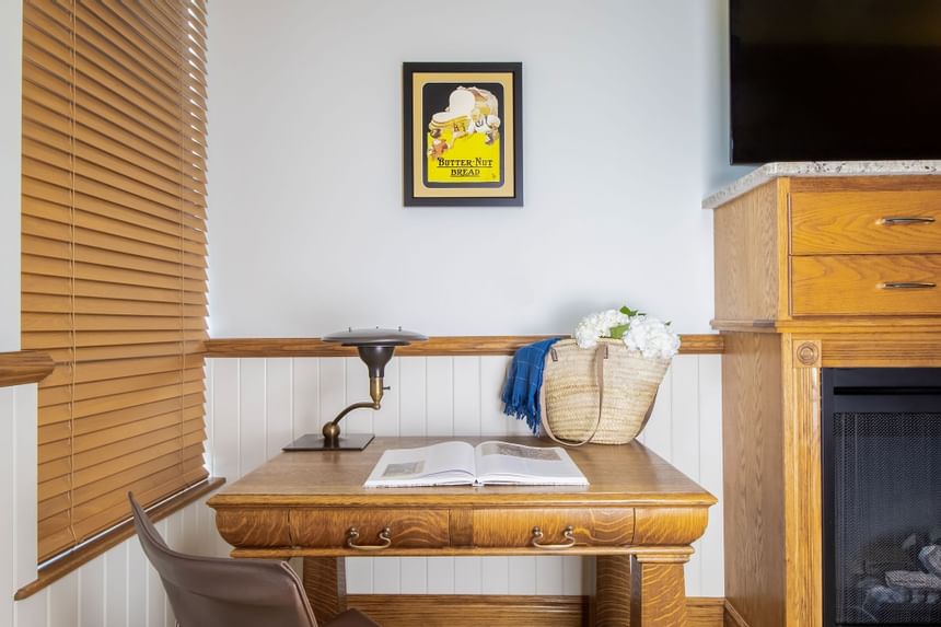 Magazine, woven bag with flowers & lamp on desk in King Superior Home Suite Home at Retro Suites Hotel