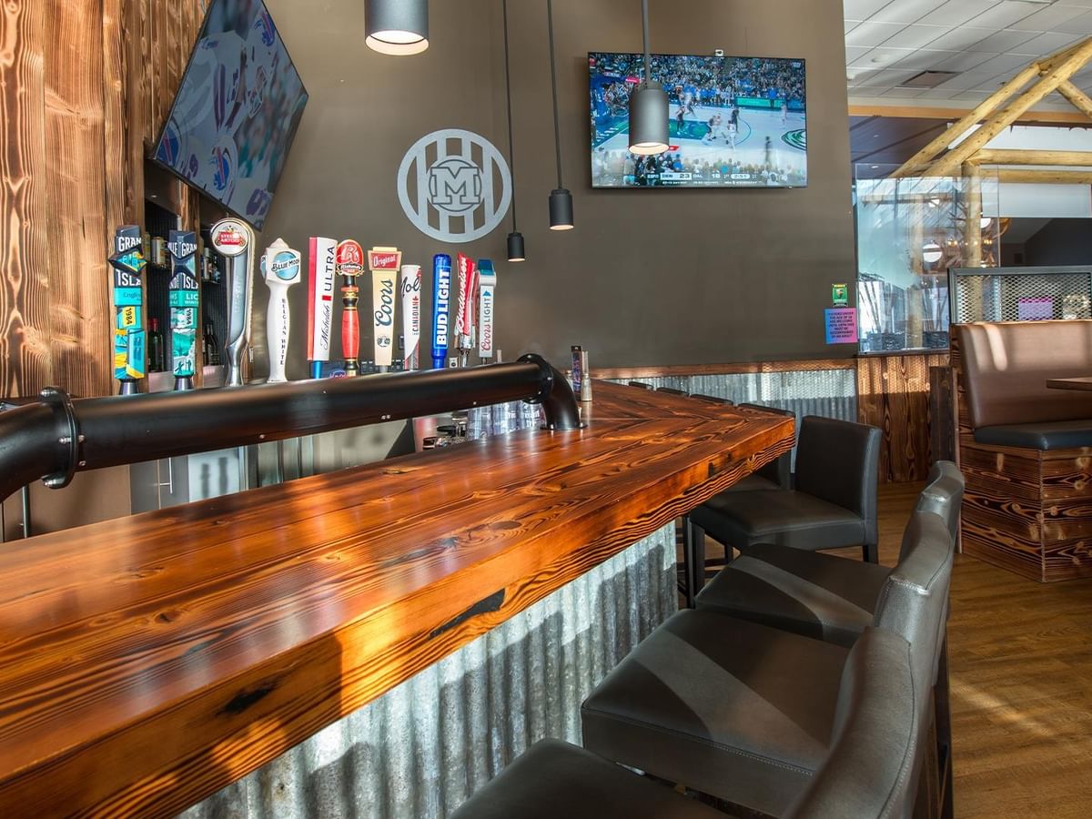 Bar counter with beer taps and rustic decor at Montana's BBQ & Bar.