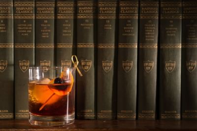 Close-up of a cocktail on a bookshelf at The Inn at Saratoga