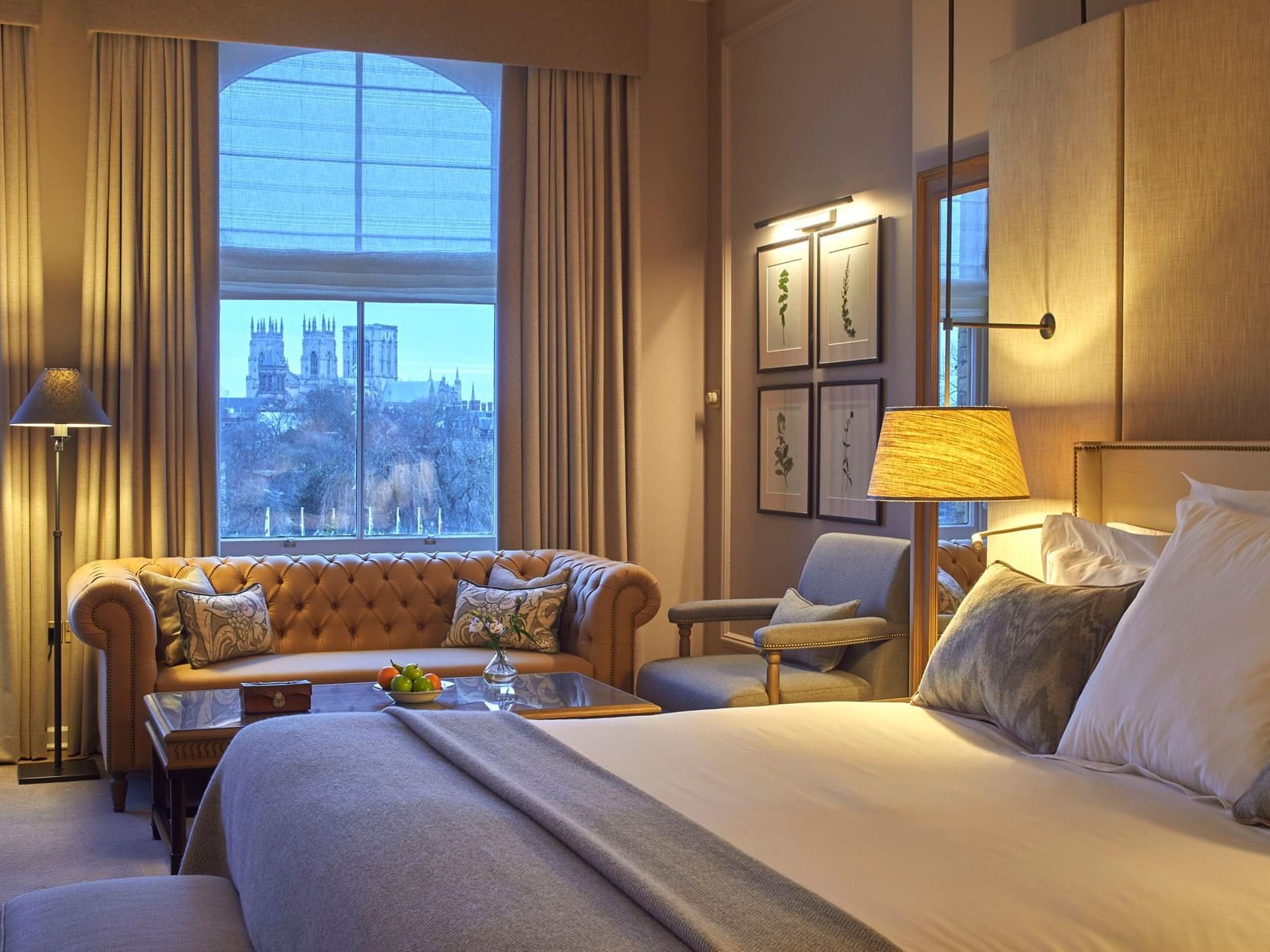 Sofa & king bed by the window in Minster View Suite, accommodation at York in The Milner York