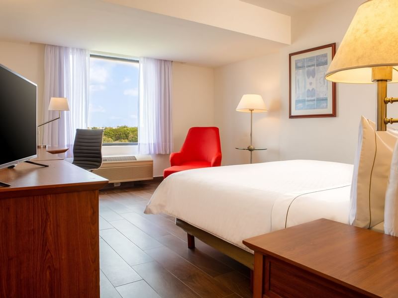 Closeup on king bed & lounge in Superior Room at Fiesta Inn