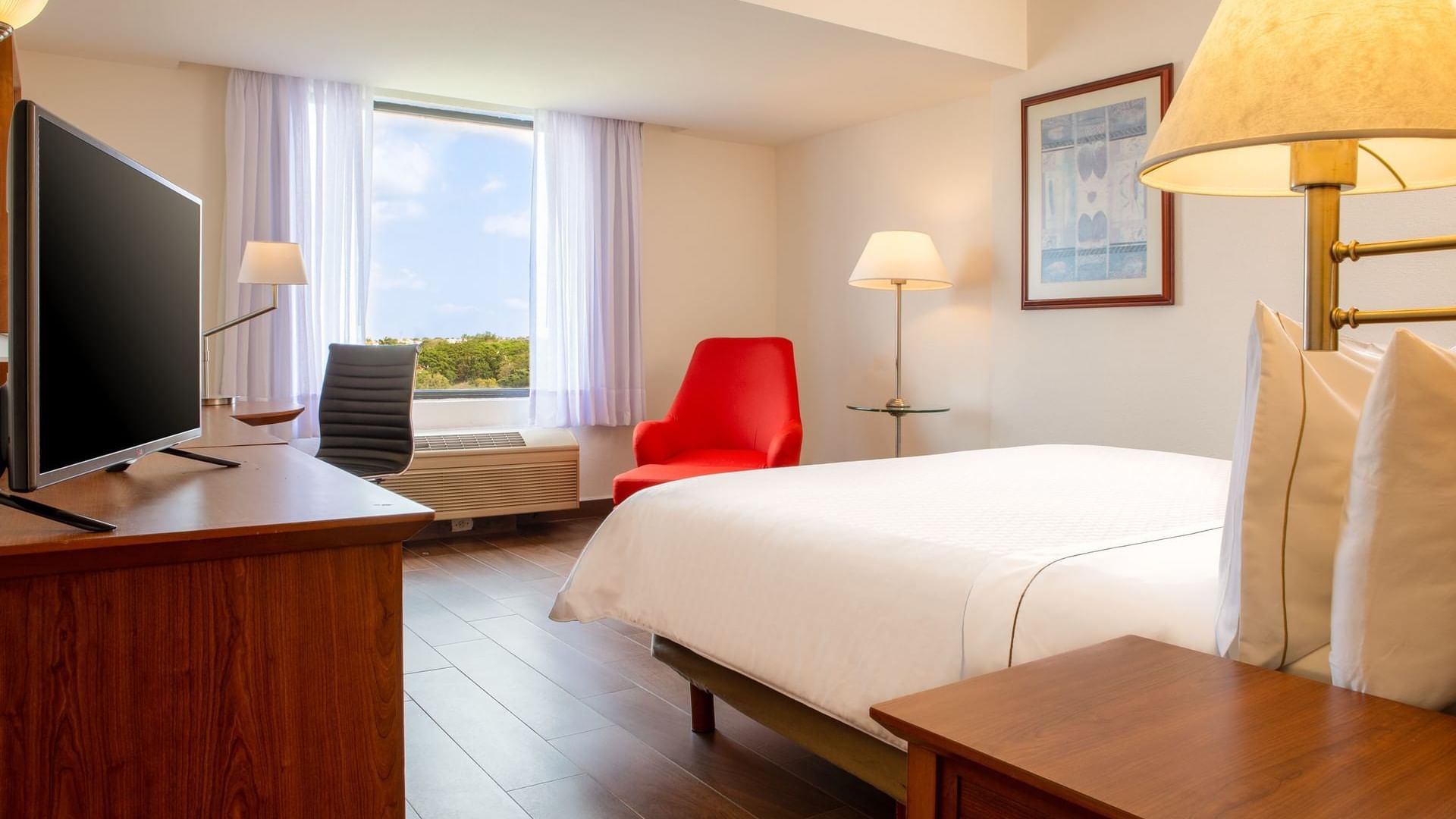 King bed & furniture in a room at Fiesta Inn Tampico