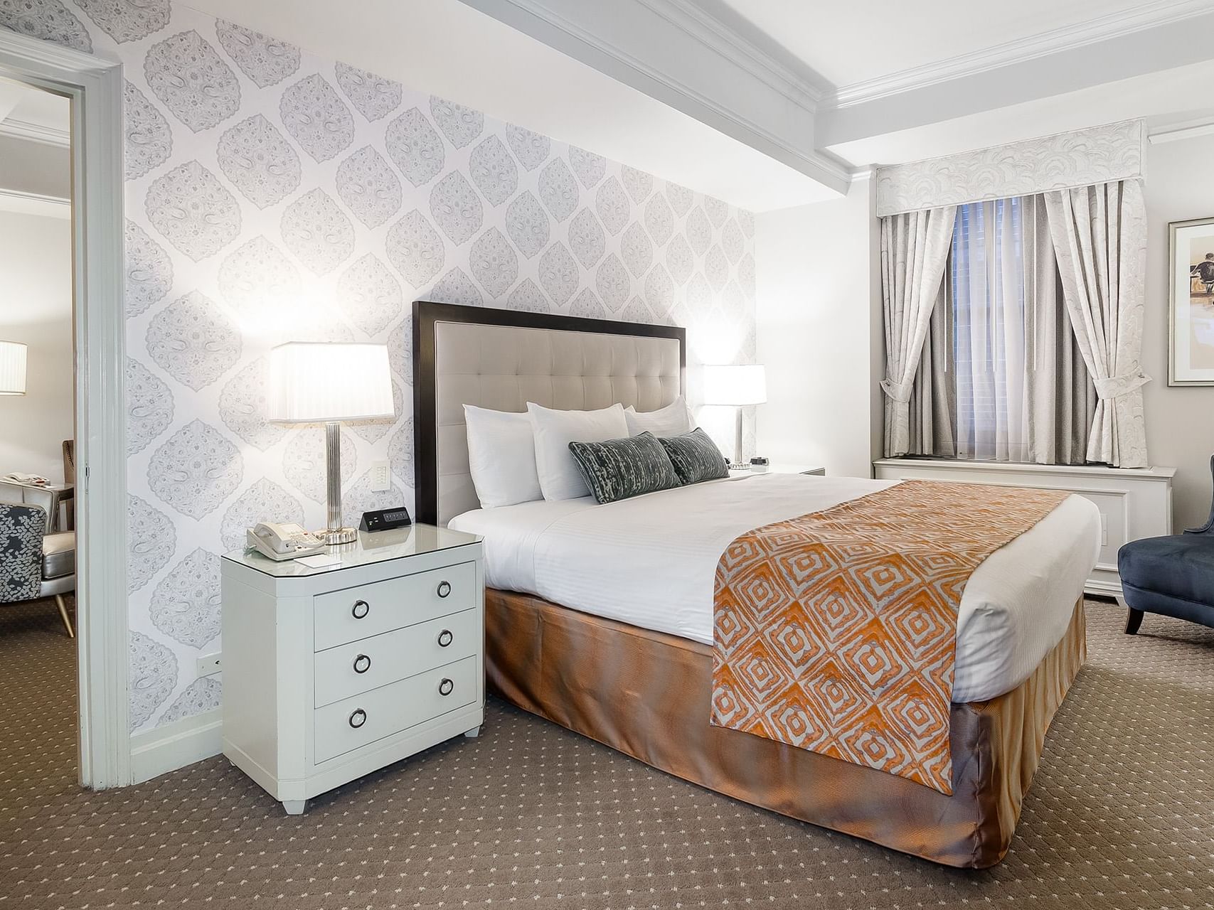 Comfy bed with side tables and TV in Premier Suite at Warwick New York