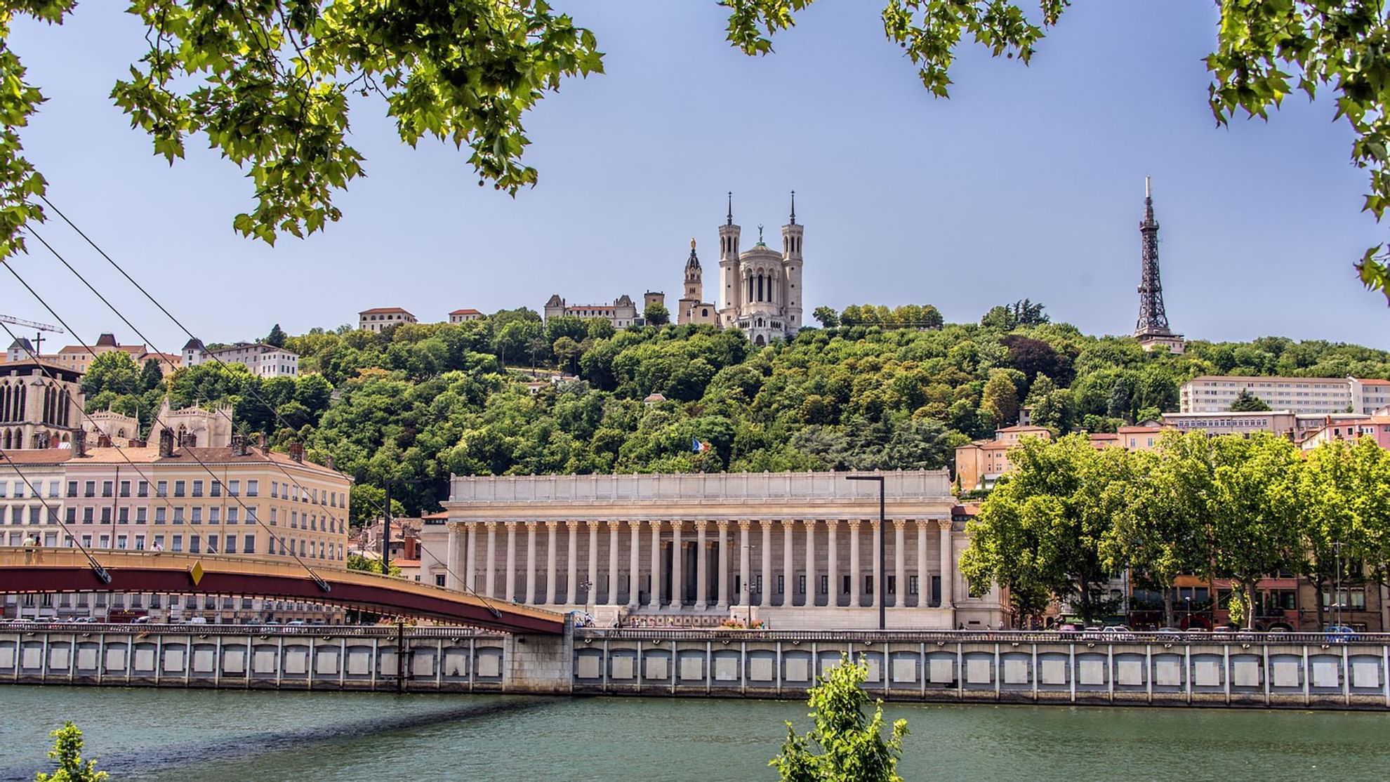 View of the Saône River with a grand building and a bridge near Warwick Hotels and Resorts