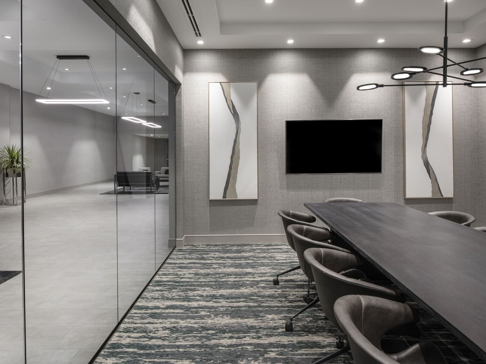 a conference table facing a tv