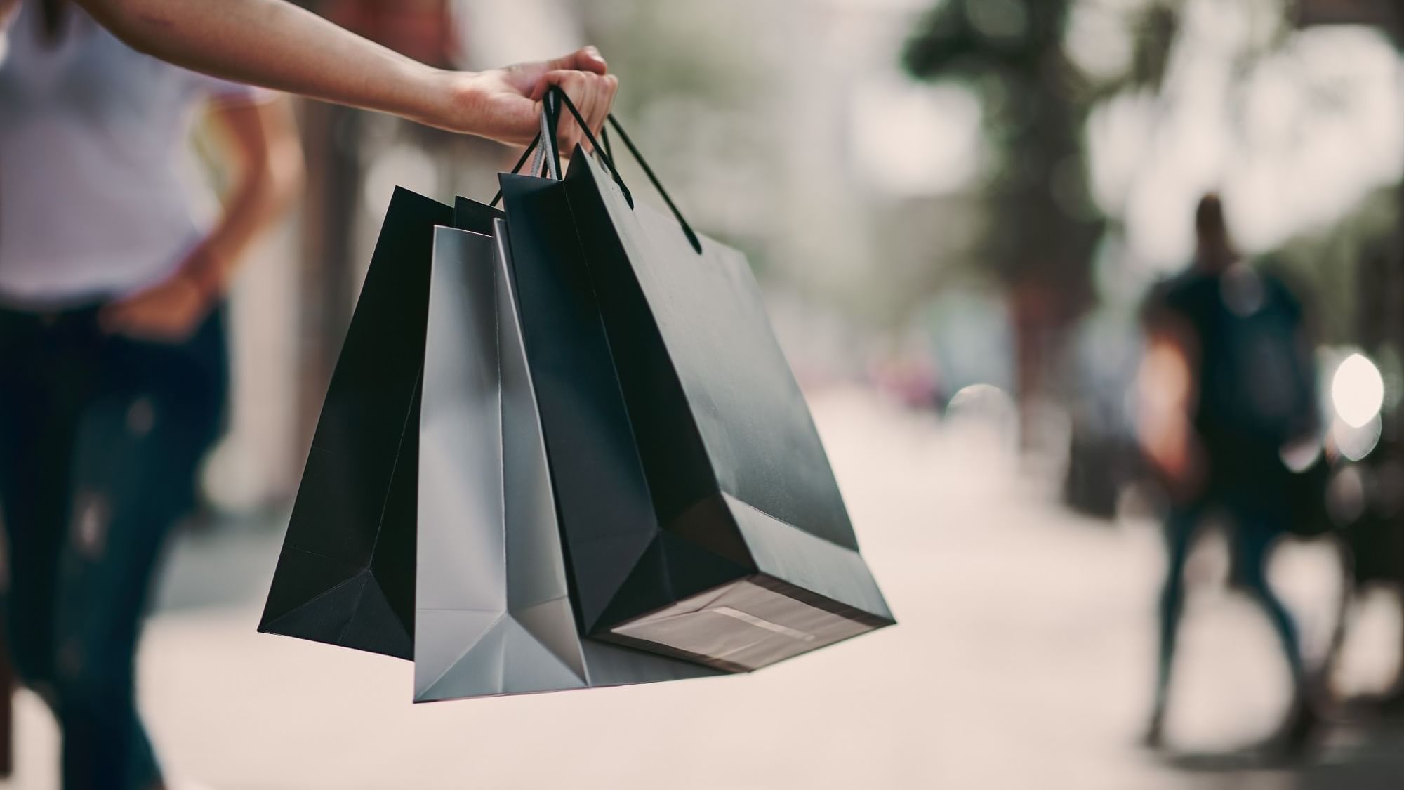 Close-up of a girl holding shopping bags near Originals Hotels