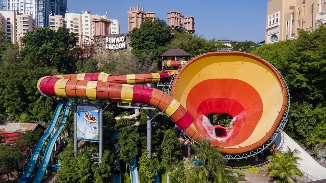 Water slide at Sunway Lagoon theme park against urban backdrop near Sunway Velocity Hotel