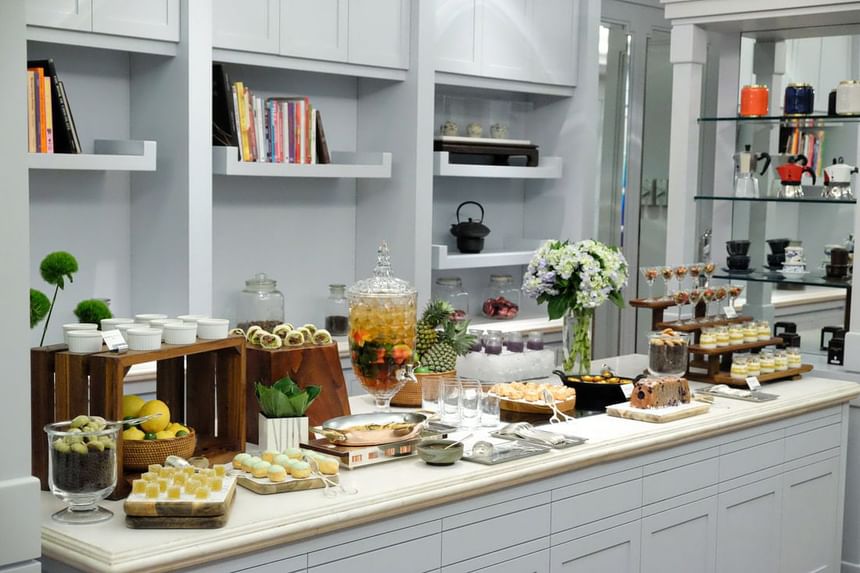 Elegant dessert display featuring floral arrangements, layered parfaits, pastries, and colorful treats at Park Hyatt Saigon