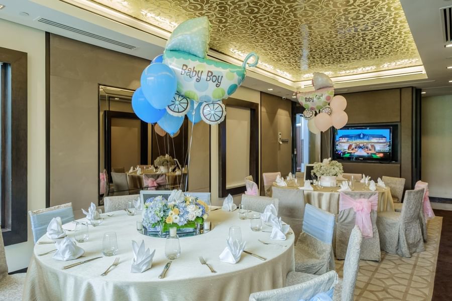 Table set-up for a baby shower with flowers & balloon décor at The Fullerton Hotel Singapore