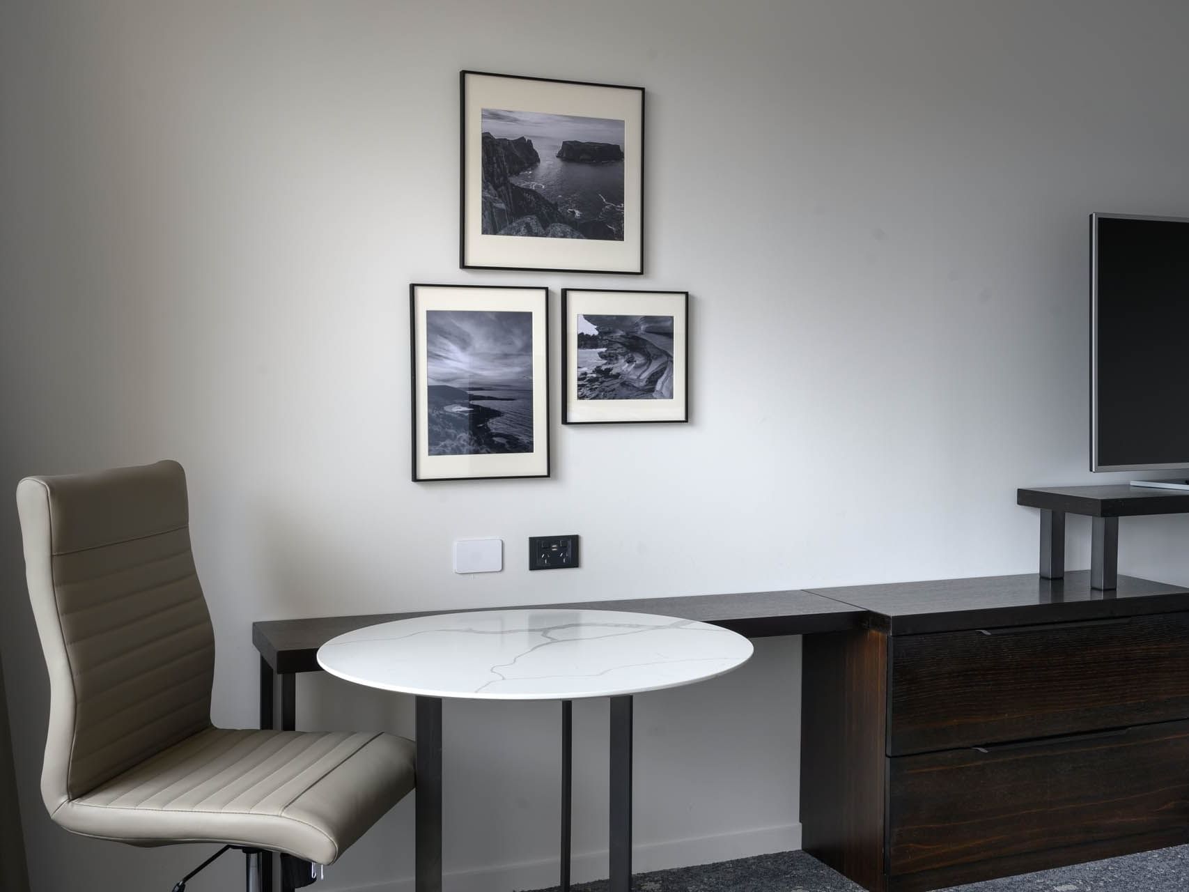 White desk, chair and scenic pictures on a white wall in Standard City Side room at Hotel Grand Chancellor Hobart