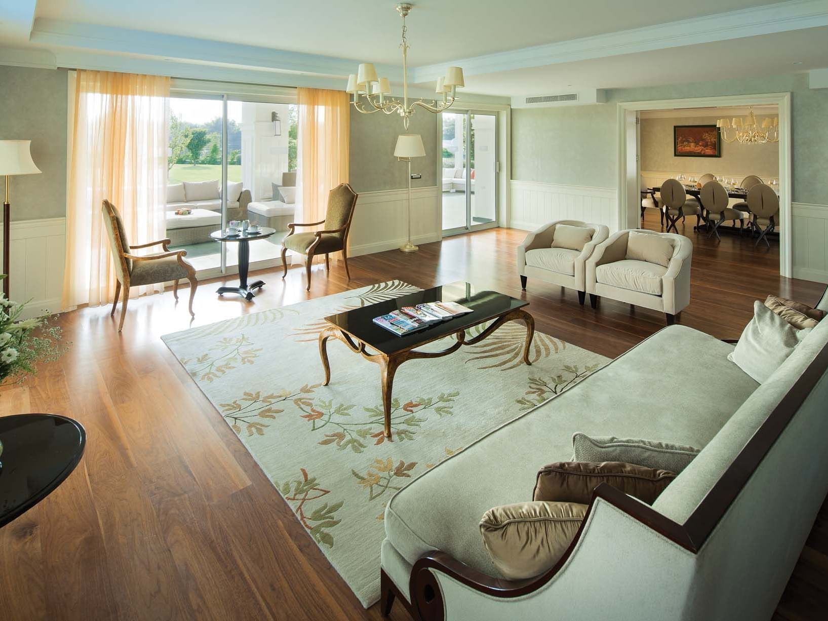 Living area with sofa, chairs, and dining area in a room at Titanic Deluxe Golf Belek