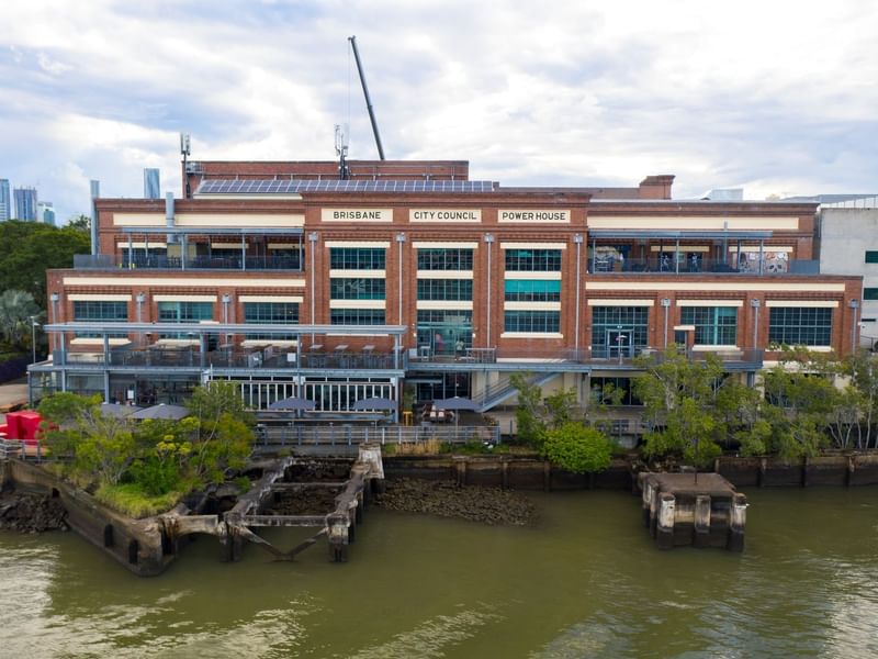 Aerial view of Brisbane Powerhouse beside a river near Sofitel Brisbane Central