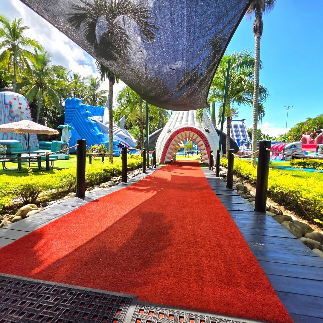 Big Bula Waterpark Nadi with Red carpet path leading to a vibrant outdoor play area near TokaToka Resort Nadi Fiji