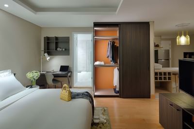 expansive bedroom with king bed and wardrobe