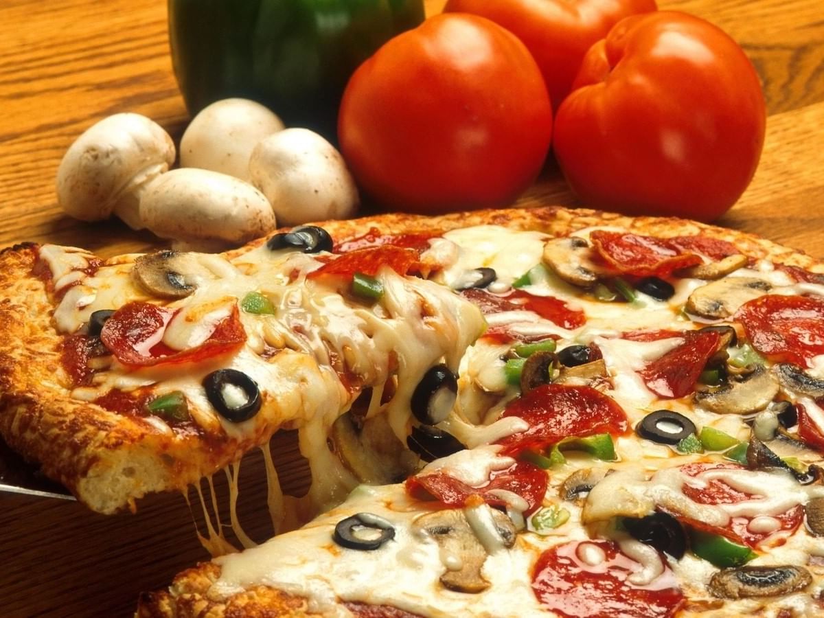 Cheese pizza with pepporoni, black olives, mushrooms and green peppers
