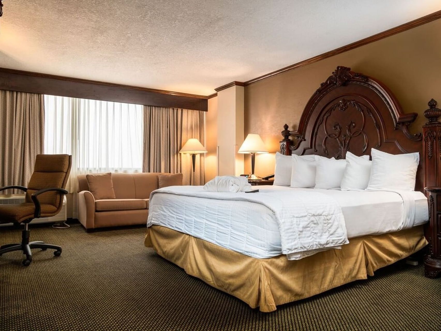 King bed of Concierge king room at MCM Elegante Beaumont