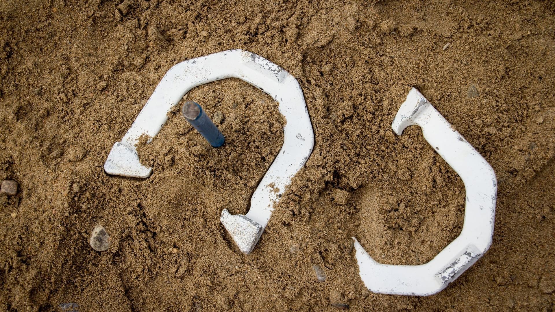 Close-up of Horseshoes on the sand, featuring the Horseshoe game at Cove Pocono Resorts