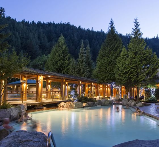 View of outdoor pool area in nighttime at Poets Cove Resort & Spa