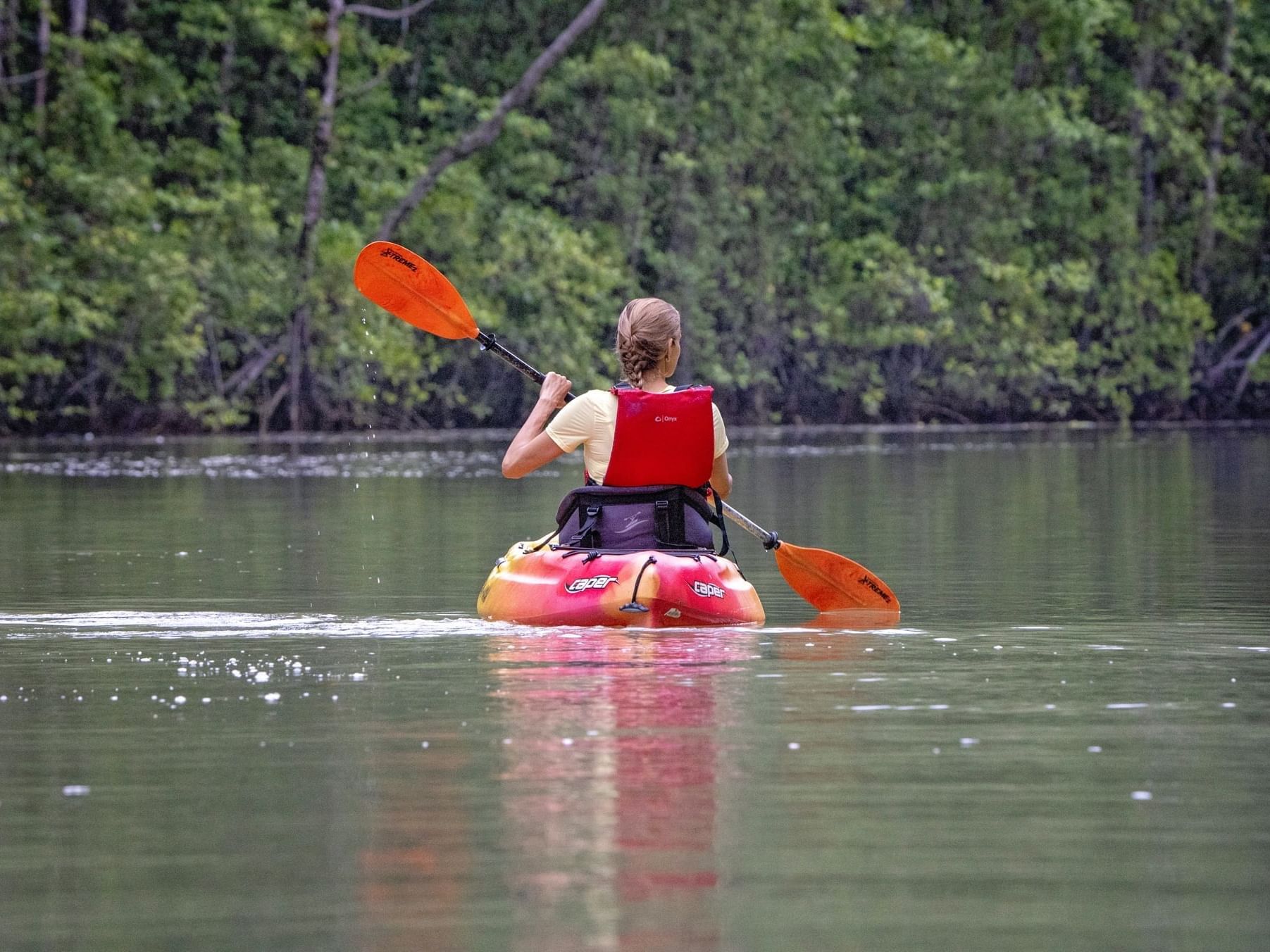 Lady kayaking in Cativo Bay near Playa Cativo Lodge