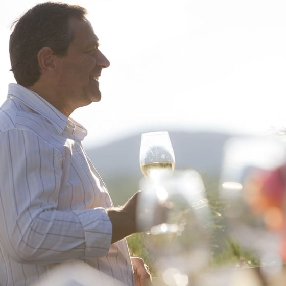 Gentleman holding glass of wine.