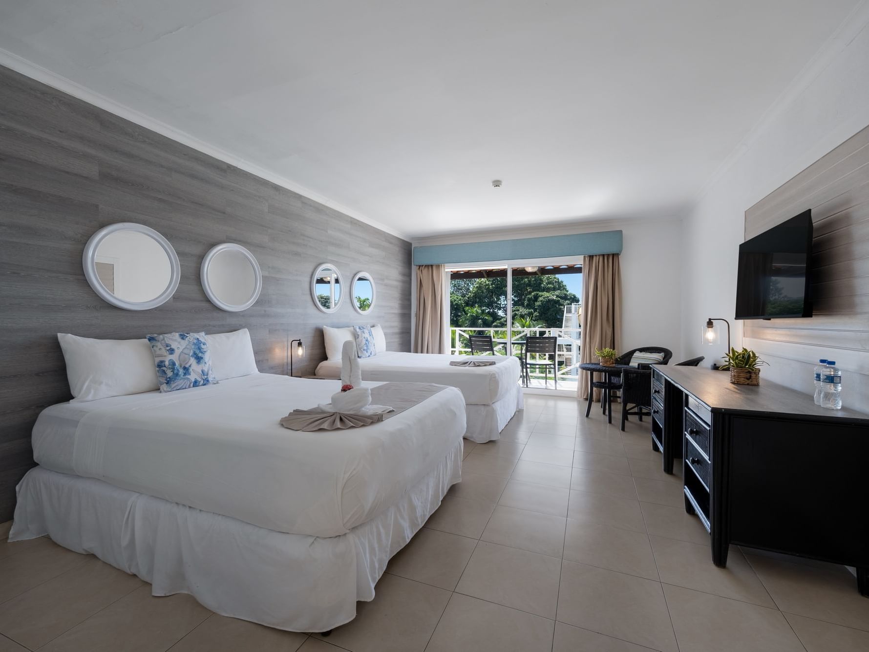 Pool View room with two beds, balcony, and modern furnishings at Playa Blanca Resort in Rio Hato.