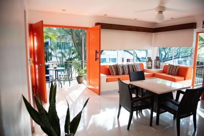 Dining table and comfy sofa in the living lounge of Premium Room at Cha Cha Hotel