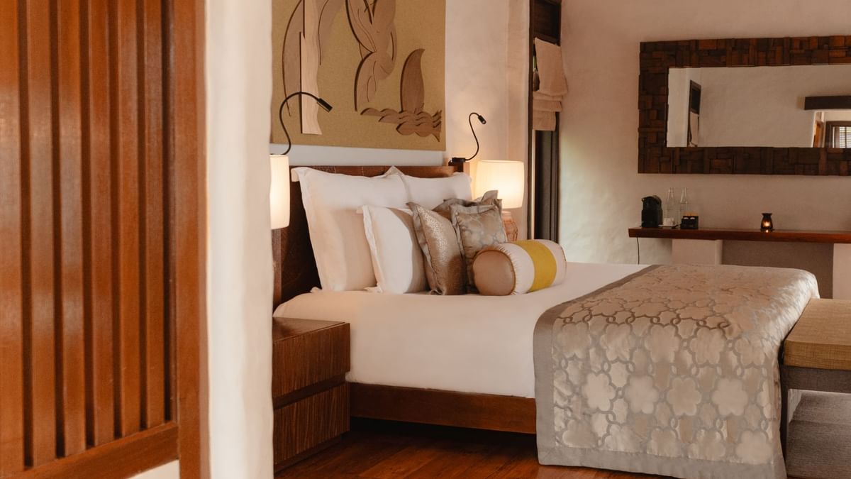 Cozy King-sized bed with warm lighting in Water Villa at The Banjaran Hotsprings Retreat