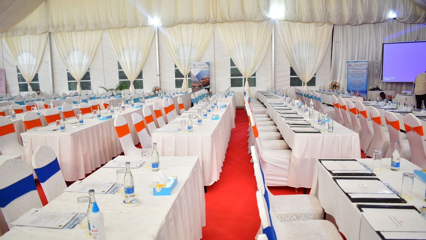 Elegantly arranged conference room setup with white drapes and chairs at Serena Beach Resort & Spa in Mombasa.
