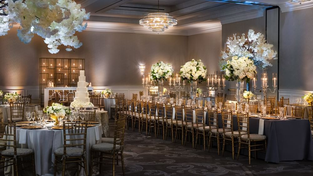 Turtle Creek Ballroom set for an event with floral decor and elegant dining at Warwick Melrose - Dallas.