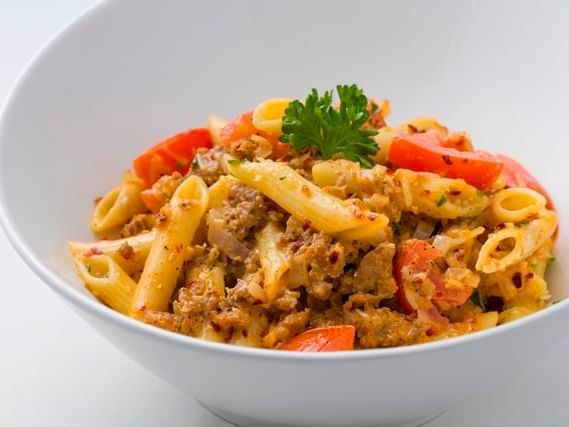 Bowl of pasta with tomatoes and meat at Mission Inn Riverside