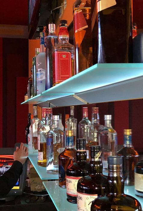 Close-up of a bar rack with wine bottles, Pegasus Hotel Guyana