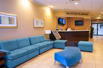 Waiting area and a desk in the hotel lobby at Rosen Inn International