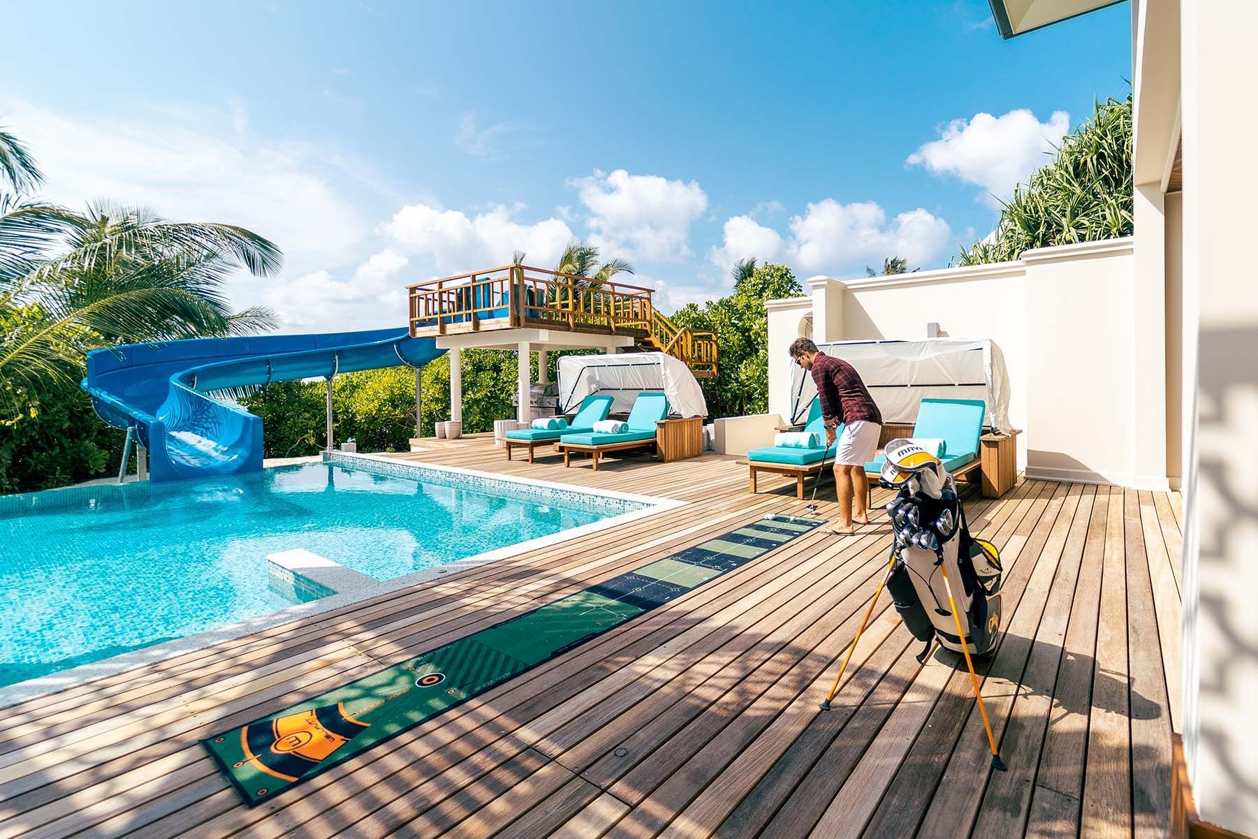 Training golf on a putting mat, pool, The Signature Collection