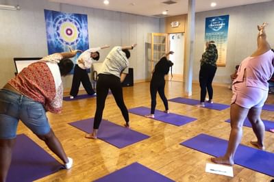 People stretching at self-healing yoga session at Honor’s Haven Retreat