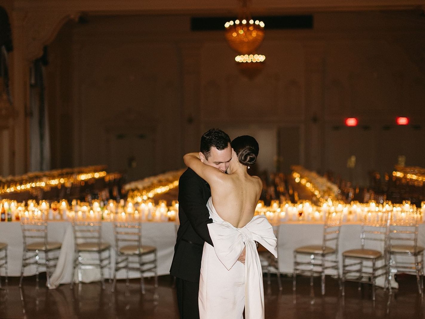 Bride and groom hugging in their reception at The Mayo Hotel