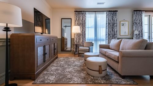 Lounge area with a comfy sofa by the window in Junior Golf Suite at Camp Creek Inn