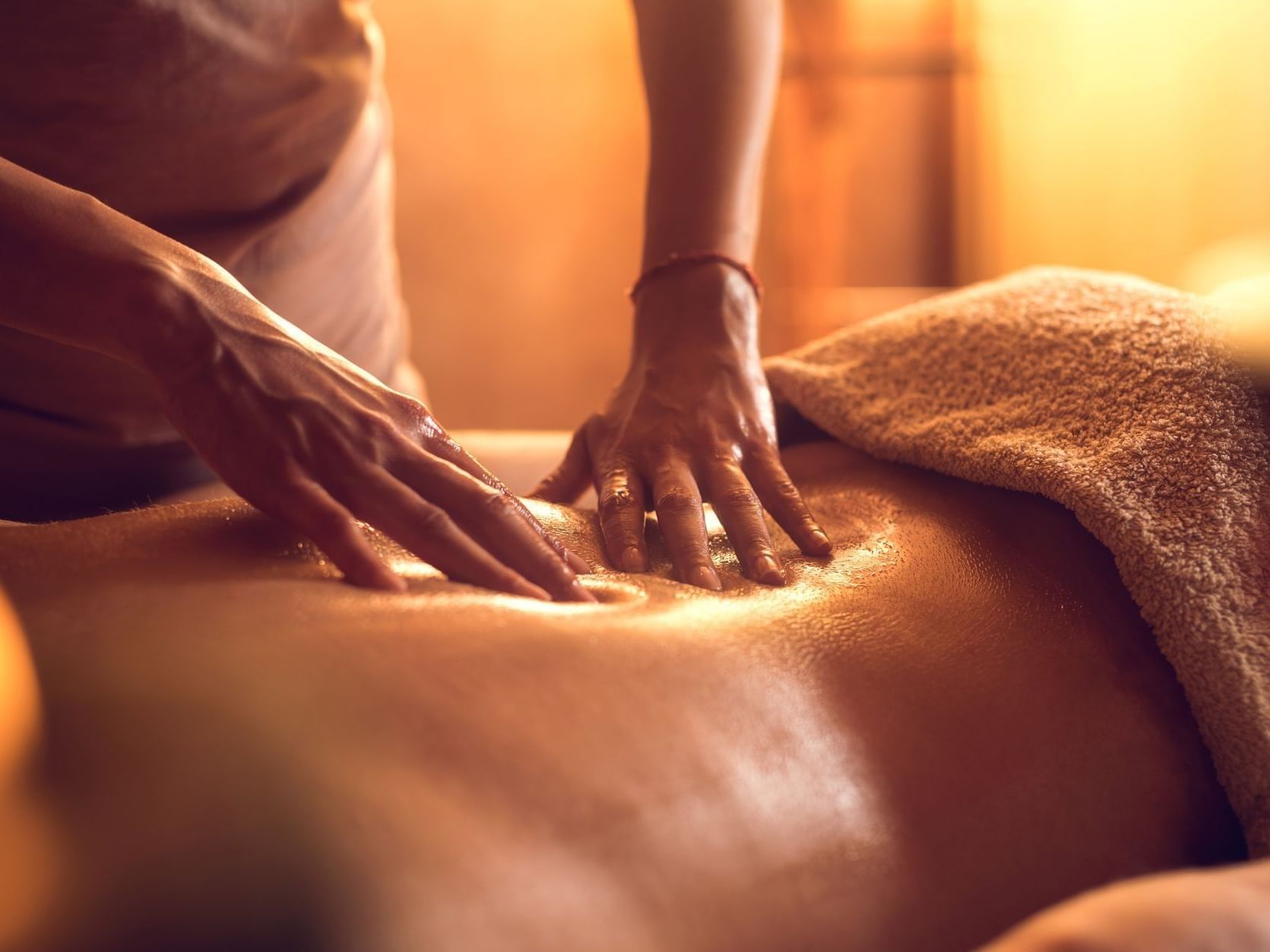 Close-up of a Back Oil Therapy in the Spa at Ana Hotels